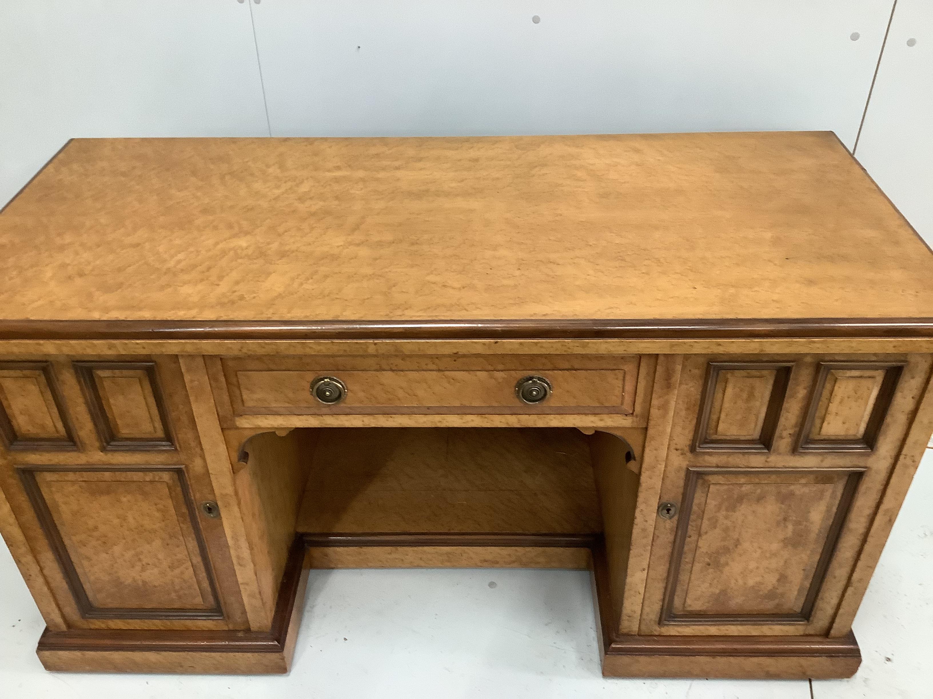 A late Victorian bird's eye maple kneehole desk by Moore and Hunton, London, width 140cm, depth 60cm, height 76cm